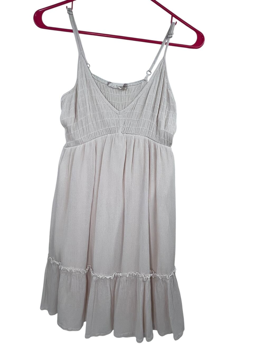 Cream-colored smocked mini dress from Altar'd State